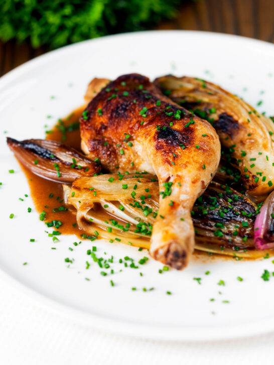 Baked chicken leg, Belgian endive and shallots with balsamic gravy and snipped chives.