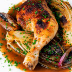 Baked chicken leg, Belgian endive and shallots with balsamic gravy and snipped chives.