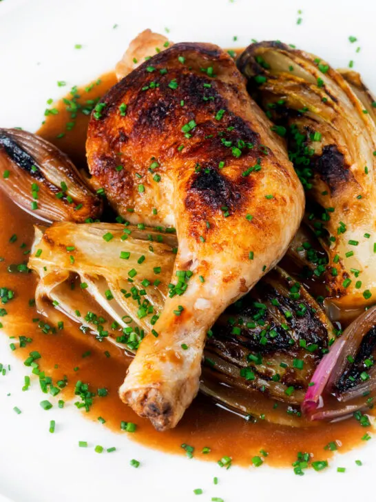 Baked chicken leg, Belgian endive and shallots with balsamic gravy and snipped chives.