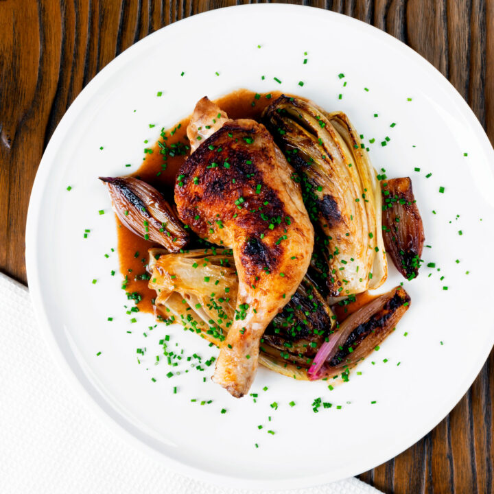 Roasted chicken legs and chicory with shallots and a balsamic gravy served with snipped chives.