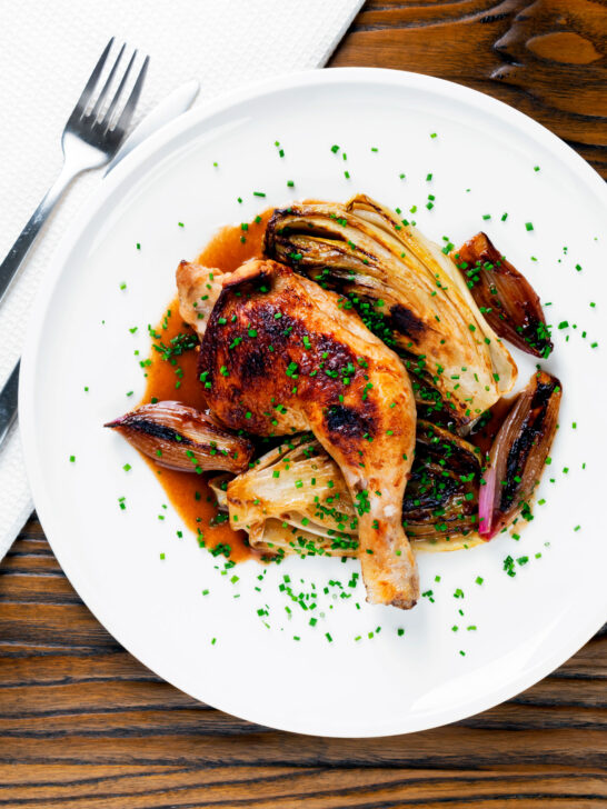 Overhead roasted chicken leg, chicory or Belgian endive and shallots with balsamic gravy.