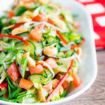 Spicy cucumber salad with tomato, chilli and toasted peanuts.