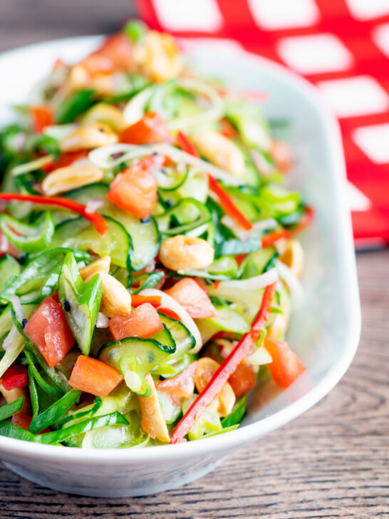 Spicy cucumber salad with tomato, chilli and toasted peanuts.