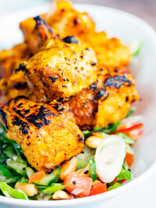 Salmon tikka served with a spicy cucumber salad with tomato, chilli and toasted peanuts.