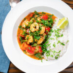 Overhead Thai prawn panang curry with jasmine rice and fresh coriander.
