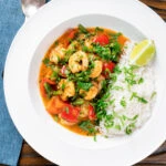 Overhead Thai prawn panang curry with jasmine rice and fresh coriander.