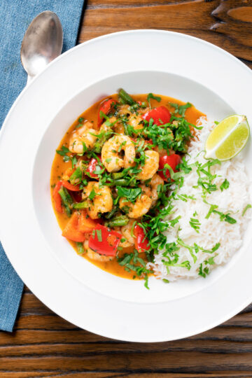 Overhead Thai prawn panang curry with jasmine rice and fresh coriander.