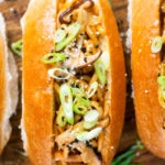 Japanese yakisoba pan stir-fried udon noodles with pickled ginger and spring onions in a bun.