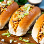 Japanese yakisoba pan stir-fried udon noodles served in a hot dog bun featuring a title overlay.