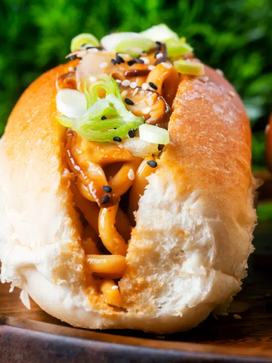 Close-up Japanese yakisoba pan stir-fried udon noodles served in a hot dog bun.