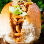 Close-up Japanese yakisoba pan stir-fried udon noodles served in a hot dog bun featuring a title overlay.