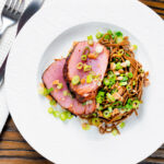 Overhead baked tuna steak with a honey and soy glaze served with a soba noodle salad.