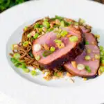 Baked tuna steak with a honey and soy glaze served with a soba noodle salad featuring a title overlay.