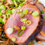Close-up baked tuna steak with a honey and soy glaze served with noodle salad featuring a title overlay.