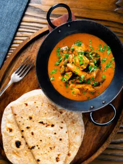 Overhead Sri Lankan influenced chicken Ceylon curry with homemade chapatis.