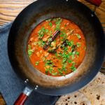 Overhead Sri Lankan influenced chicken Ceylon curry served in a wok.