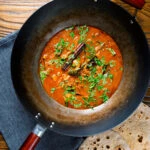 Overhead Sri Lankan influenced chicken Ceylon curry served in a wok.