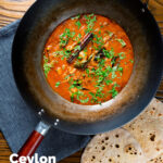 Overhead Sri Lankan influenced chicken Ceylon curry served in a wok featuring a title overlay.