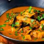 Close-up Sri Lankan influenced chicken Ceylon curry with homemade chapatis.