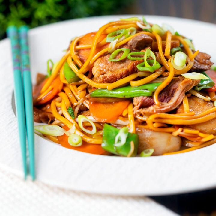 Chinese takeaway style hoisin duck chow mein stir fry with noodles, carrots and runner beans.