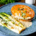 Individual English ham, potato and apple fidget pie with a cider sauce and leeks.