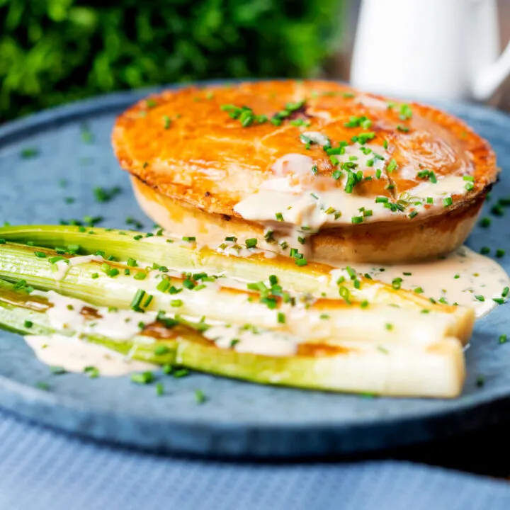 English fidget or fidgety pie with a creamy cider sauce and baby leeks.