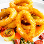 Fried and breaded calamari rings with romesco sauce, leeks, chorizo and capers.