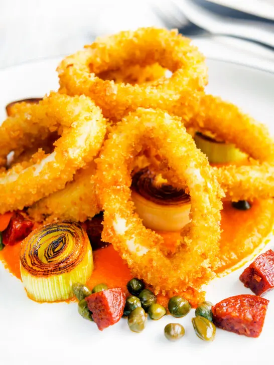 Fried and breaded calamari rings with romesco sauce, leeks, chorizo and capers.