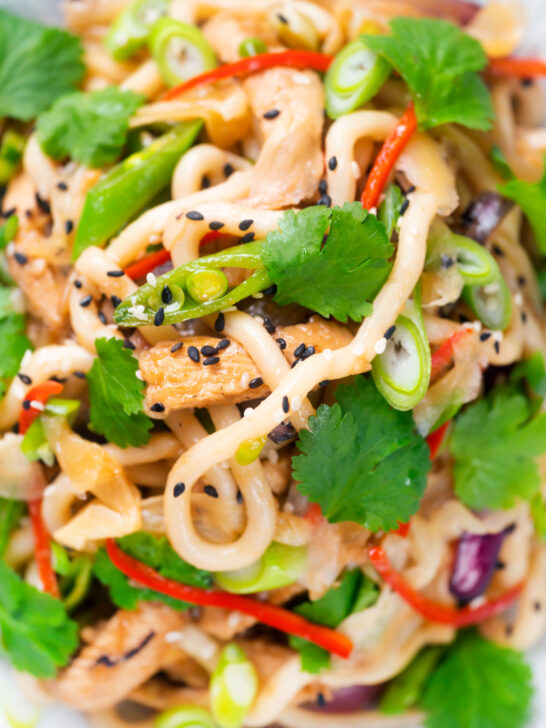 Overhead close-up Wagamama influenced ginger chicken udon noodle stir fry.