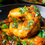 Close-up king prawn or shrimp bhuna served with fresh coriander.
