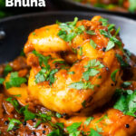 Close-up king prawn or shrimp bhuna served with fresh coriander featuring a title overlay.
