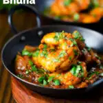 Indian king prawn or shrimp bhuna curry served with fresh coriander featuring a title overlay.