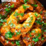 Close-up overhead king prawn or shrimp bhuna served with fresh coriander featuring a title overlay.