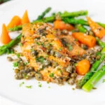 Lemon and caper chicken breast piccata served with asparagus and carrots.
