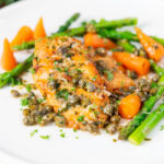 Lemon and caper chicken breast piccata served with asparagus and carrots featuring a title overlay.