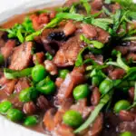 Close-up Vegetarian mushroom pearled barley risotto or orzotto cooked with red wine and peas.