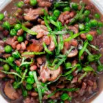 Close-up overhead mushroom pearled barley risotto or orzotto cooked with red wine and peas.