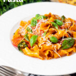 Spicy nduja pasta made with Fiorelli, tomatoes and fresh basil featuring a title overlay.
