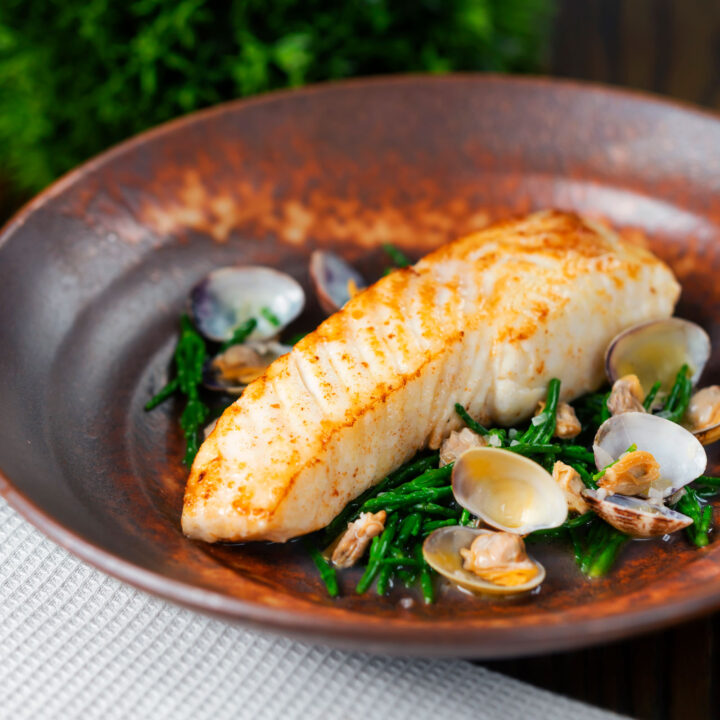 Pan fried halibut fillet with clams and samphire in a butter and white wine sauce.