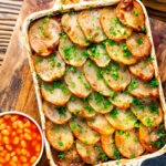 Overhead corned beef and potato bake or panacalty with baked beans.