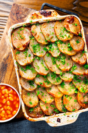 Overhead corned beef and potato bake or panacalty with baked beans.