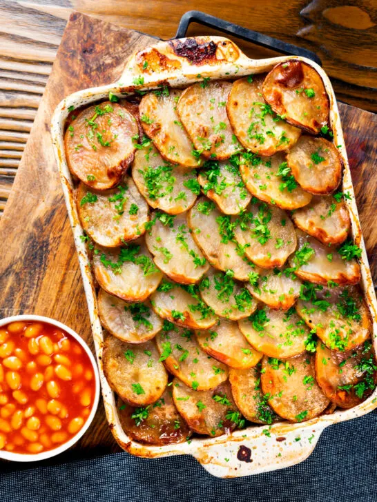 Overhead corned beef and potato bake or panacalty with baked beans.