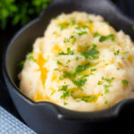 Creamy, buttery and perfectly fluffy mashed potatoes with fresh parsley garnish.