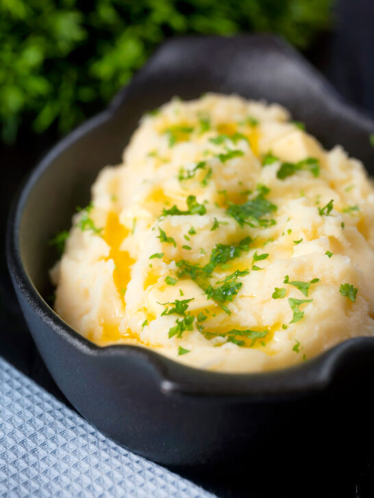 Creamy, buttery and perfectly fluffy mashed potatoes with fresh parsley garnish.