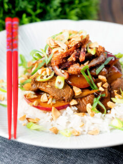 Plum and duck stir fry with crispy skin, toasted peanuts and spring onions.