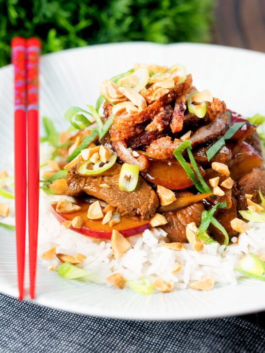 Plum and duck stir fry with crispy skin, toasted peanuts and spring onions.