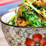 Quick and easy pork stir fry with ginger, Szechuan pepper and whole wheat noodles.
