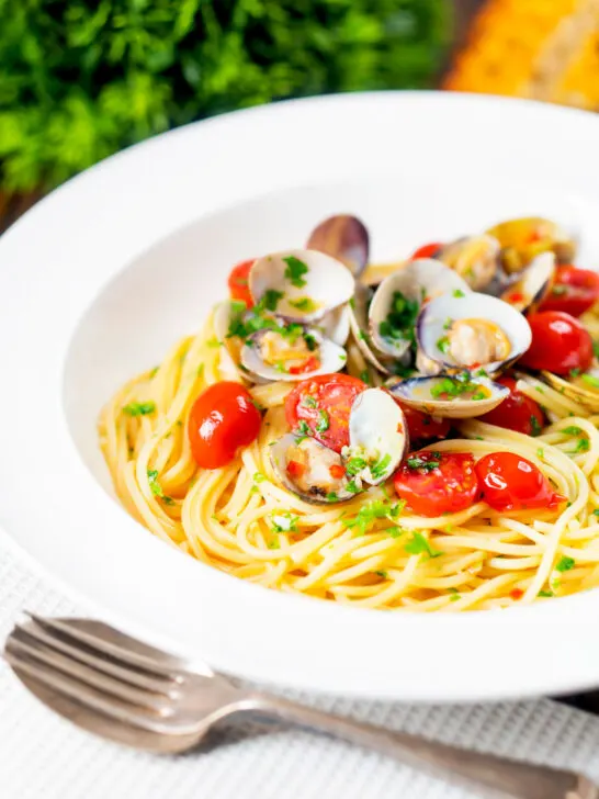 Spaghetti alle vongole or clam pasta with tomatoes, parsley and garlic.