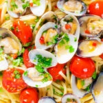 Close-up overhead clam pasta with tomatoes chilli and garlic.