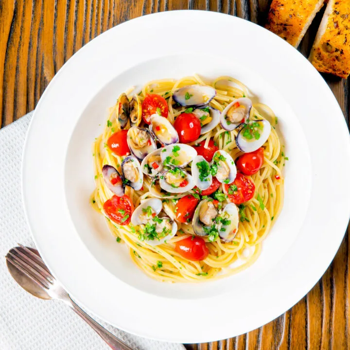 Clam pasta or Italian spaghetti alle vongole with tomatoes and chill.